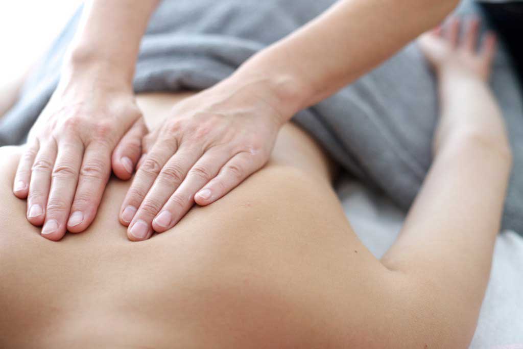 Massage therapist performing Craniosacral Therapy